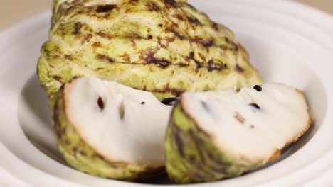 sliced custard apple displayed on a plate