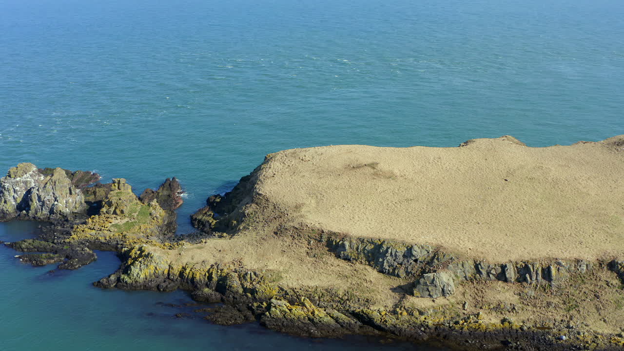 Aerial drone footage of Portmurk island's headland. County Antrim, Northern Ireland
