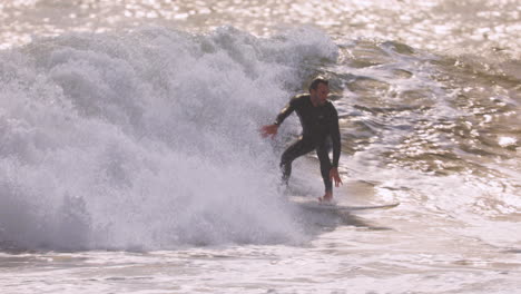 male surfer riding a wave