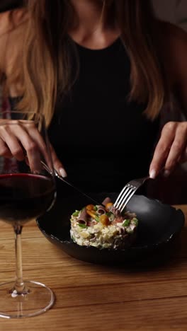 woman eating olivier salad in a restaurant