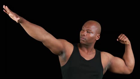 muscular man gesturing in front of camera