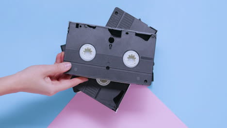 vhs cassettes on blue and pink pastel background