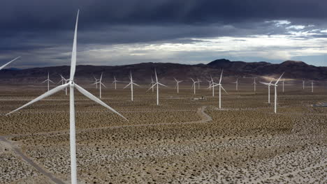 aerial view around wind turbines with a dramatic sky at a desert in arizona, usa