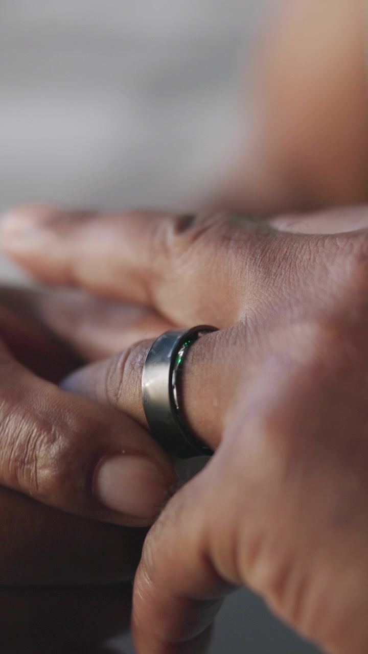 Person Adjusting a Smart Ring on Their Finger