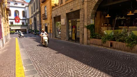 scooter rider navigating a cobblestone street