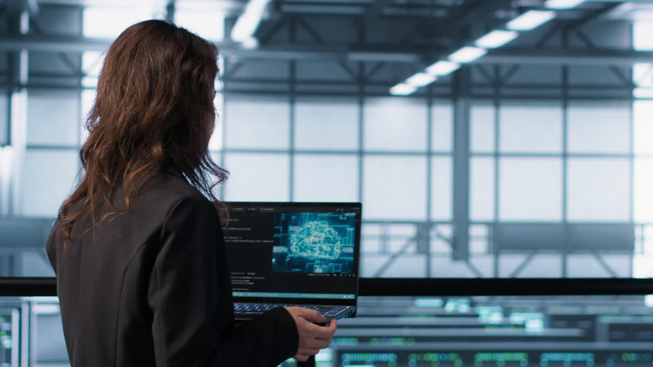 Programmers coding on laptop using artificial intelligence in server farm