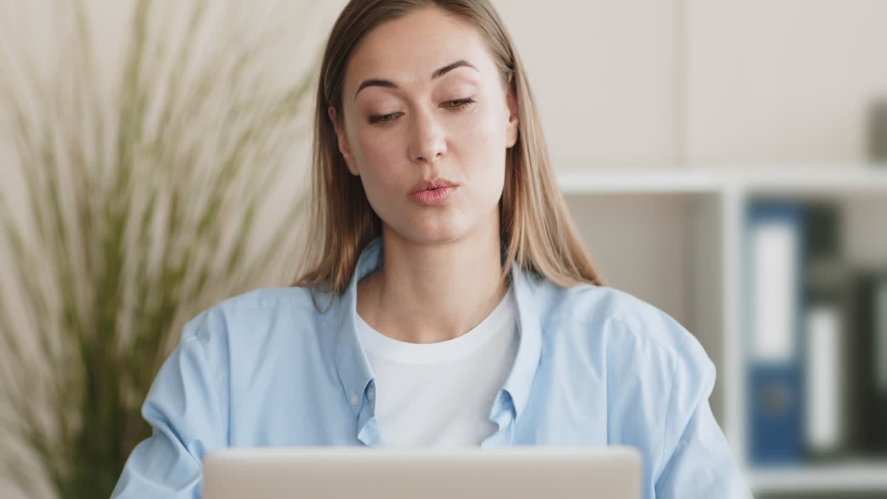 Woman looking at laptop with surprised expression