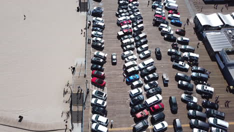 cars parking on a pier dock at the beach