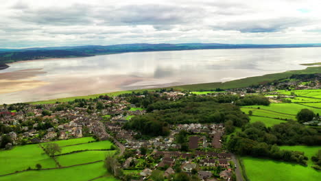 aerial view of a tidal bay with a countryside town in the foreground, bright sunny daylight