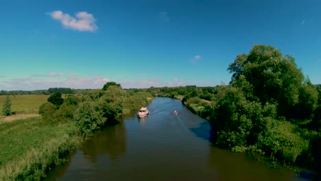 Aerial-Drone-Footage-of-a-boat-along-the-River-Waveney,-Norfolk