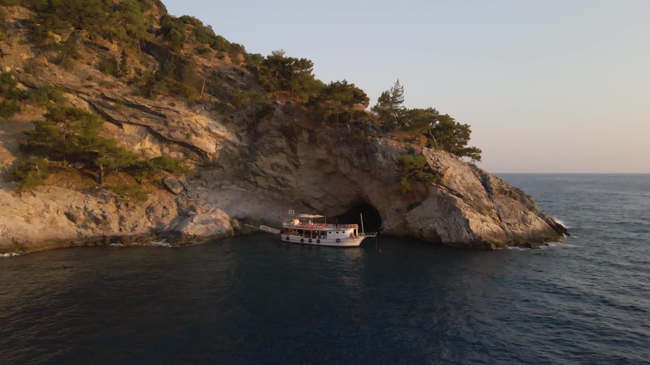 Aerial footage oludeniz turkey tourist destination, luxury boat in natural reserve coastline rock cliff formation