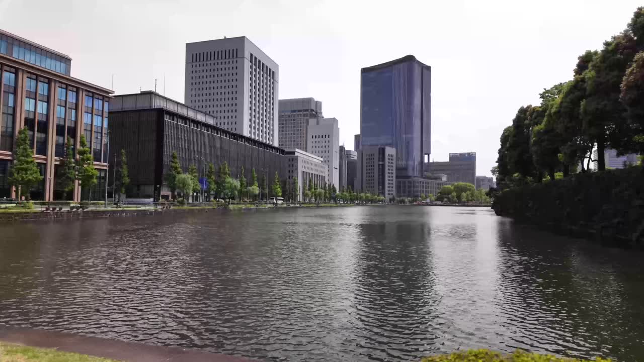 Kokyo Gaien National Garden in Tokyo, Japan with modern Japanese real estate buildings skyline