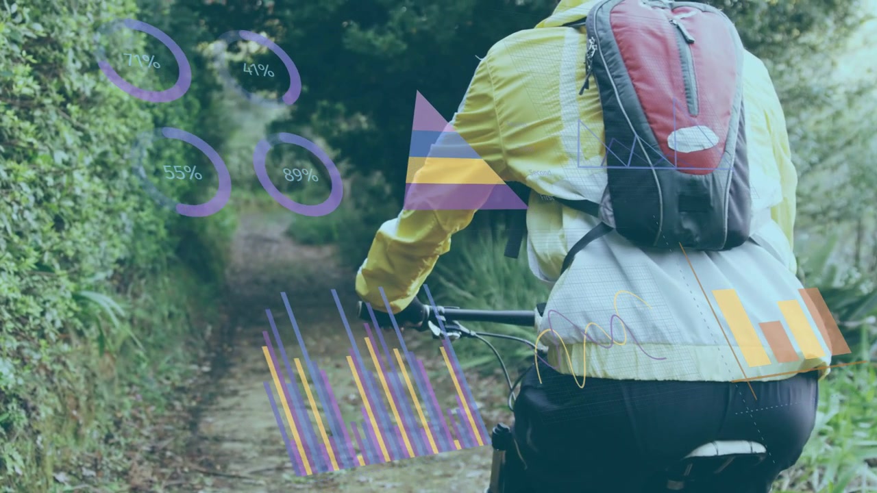 Male cyclist pedaling and steering down narrow trail, generating HUD charts showing fitness metrics