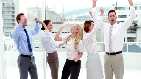 Business-people-cheering-at-the-camera