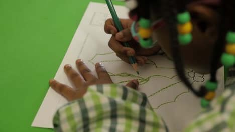 little girl drawing a paint in school