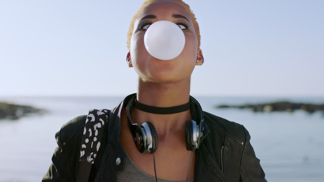 Young black woman, face and bubble gum outdoor