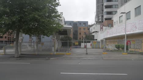 Empty-Street-With-Buildings-Enclosed-By-Metal-Fence-During-COVID-19---Sydney,-NSW,-Australia