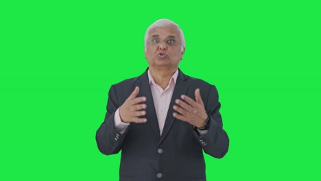 Indian-senior-manager-talking-to-someone-Green-screen