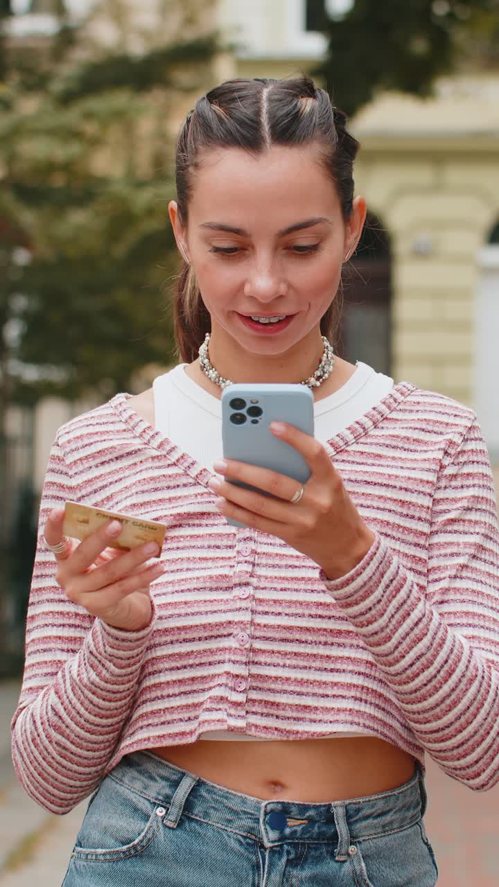 Woman using credit bank card smartphone while transferring money purchases online shopping order