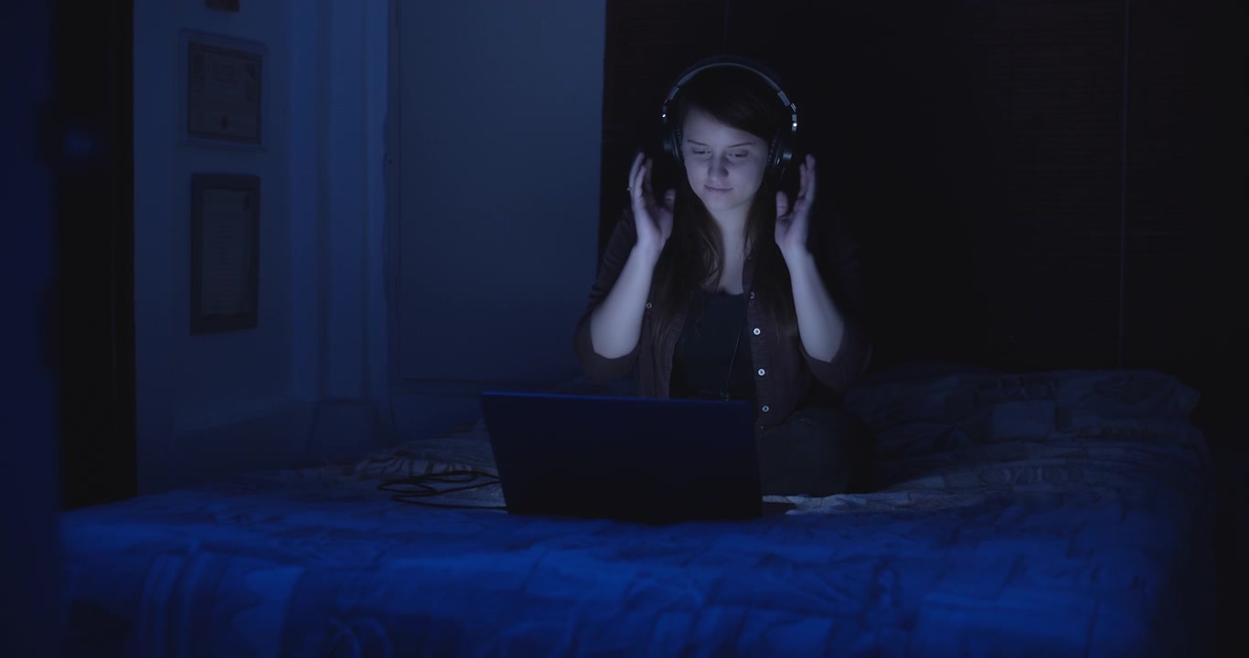Woman enjoying the music on her laptop