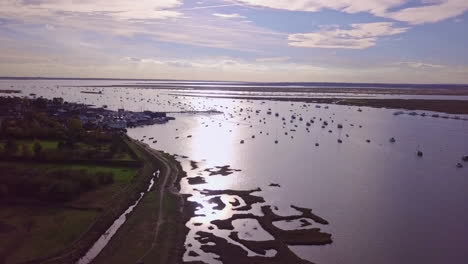 Aerial-footage-of-West-Mersea-island-harbour-at-sunset,-this-could-show-any-harbour-port-in-the-uk