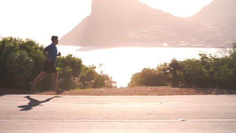 Young-man-running-on-an-empty-coastal-road