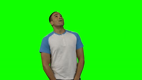 man looking around against green screen