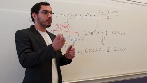 professional solving a complex formula on a board