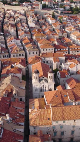 bird's-eye view of dubrovnik's historic architecture with the church focal point. aerial, vertical video