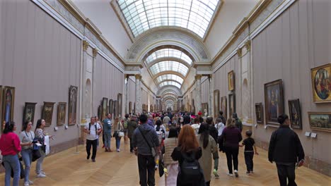 crowded hallway in the louvre museum, paris