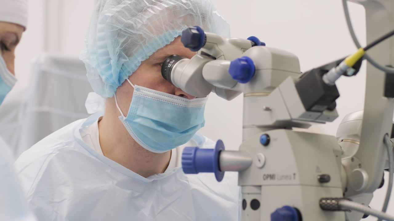 Surgery team making strabismus surgery using modern technologies, latest devices, microscope in modern clinic