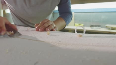 male surfboard maker in his workshop