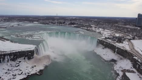 misty horseshoe falls at winter in niagara falls, high forward aerial