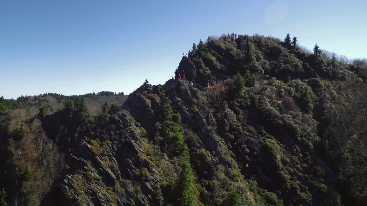Pivoting on hikers atop Charlies Bunion this aerial view lifts up to reveal the great smoky mountain cinematic landscape