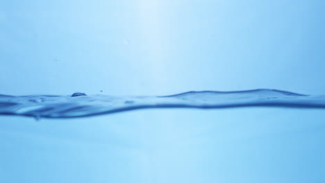 Water-waves-on-surface-with-blue-background