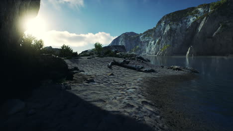 sandy-beach-in-bay-surrounded-by-steep-mountains-in-sunset