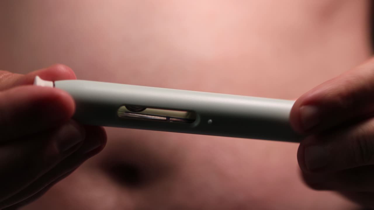 Auto application of prescription medication drugs through a medical needle pen injecting the substance in a fatty area of the belly showing how to apply and closeup of injection device with substance