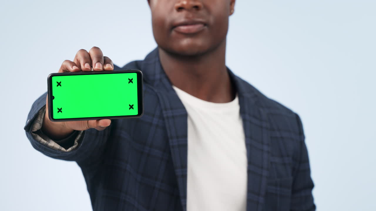 Happy man, phone and pointing to green screen