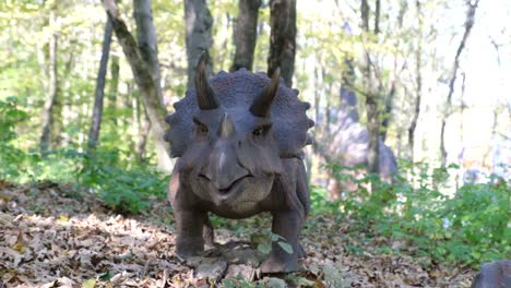 triceratops statue in a forest