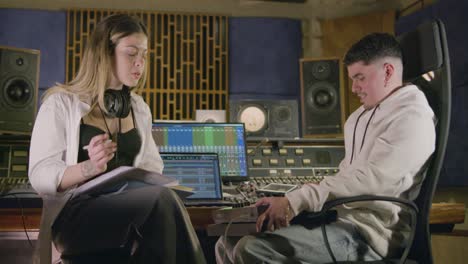 Two talented musicians working at music recording studio