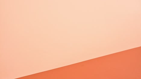 pile of hardcovered books in warm colors appear on deep and bright orange theme. stop motion