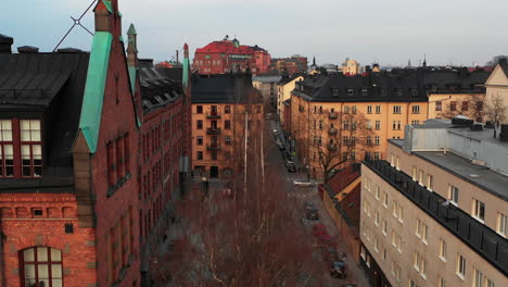 Aerial-view-of-urban-neighbourhood-from-descending-drone.-Old-red-brick-building-of-Katarina-norra-skola-school.-Stockholm,-Sweden