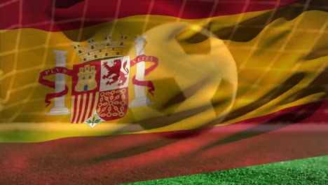 Soccer-ball-bouncing-on-grass-while-Spanish-flag-waves-on-the-foreground-on-soccer-field.