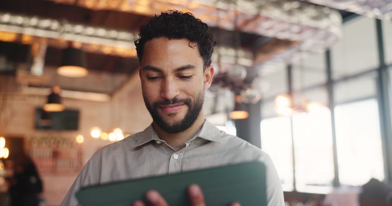Young Man Using a Tablet in a Modern Office Setting