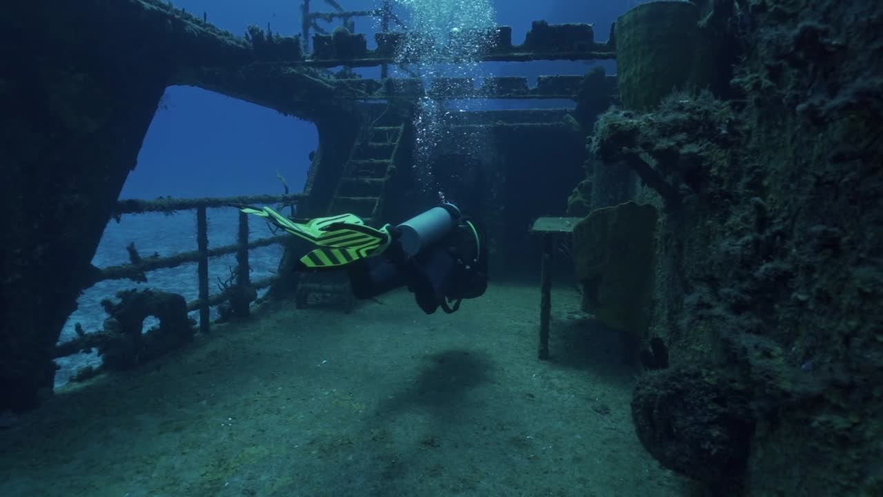 An experienced scuba diver prepares to enter the main superstructure of the ARM General Felipe Xicoténcatl (C-53) wreck off the coast of Cozumel