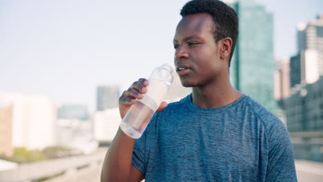 city, fitness or black man drinking water