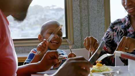 family having food at dining table in a comfortable home 4k