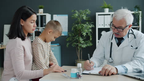 doctor examining a child with mother