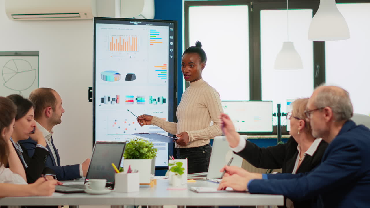 African american coach giving corporate presentation for businesspeople