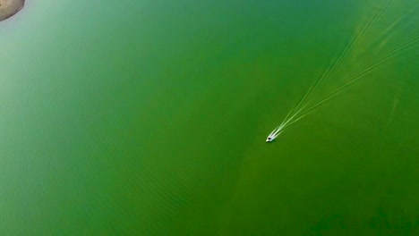 isolated speed boat running on lake water from top angle video is taken at umiyam lake shillong meghalaya india